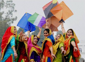 Attired in traditional dress college girls dance around a bonfire to celebrate Lohri