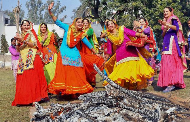 College girls perform gidha around a bonfire as they celebrate Lohri in Patiala