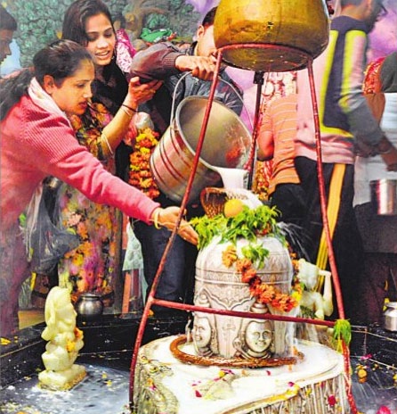 Devotees offer milk to Lord Shiva at Sheetla Mata Temple in Ludhiana