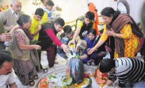 Devotees offer milk to the Shivalingam on the occasion of Mahashivratri in Chandigarh