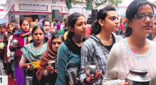 Devotees wait in a queue to pay obeisance at a Shiv temple