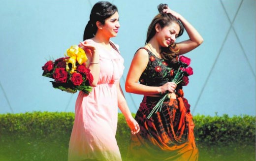Girls carry roses on Rose Day in Ludhiana