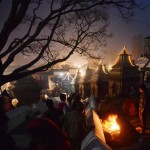 Nepalese Hindu worshippers warm themselves near a fire during the Mahashivaratri festival in Kathmandu