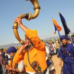 A Sikh devotee blows a horn during the Hola Mohalla festival at Anandpur Sahib on March 13, 2017