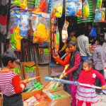 Children buy gulal and pichkari at Ram Bagh in Amritsar