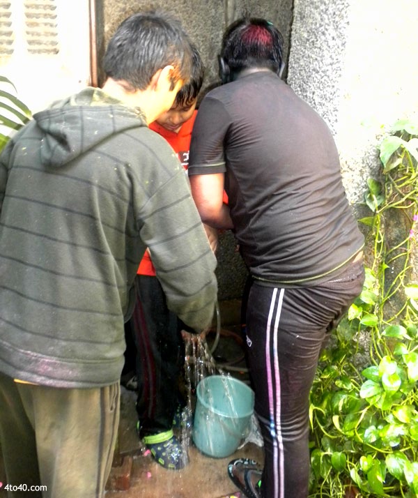 Children filling water balloons on Holi festival