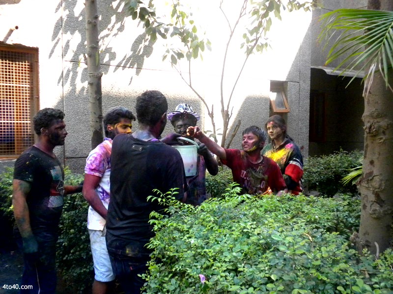 Children put colored water at each other on Holi festival