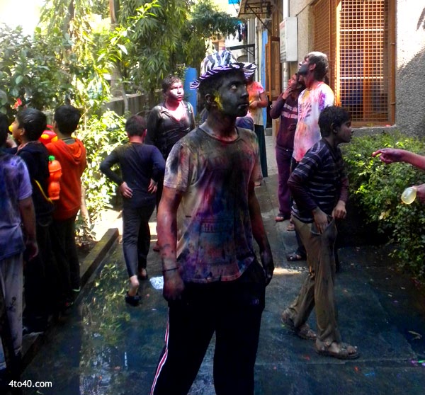 Children put colors at each other on Holi festival
