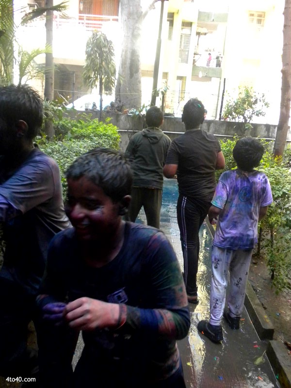 Children throw water balloons at each other on occasion of Holi