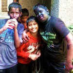 Chilren drenched in Holi colours