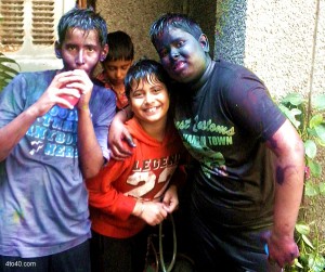Chilren drenched in Holi colours