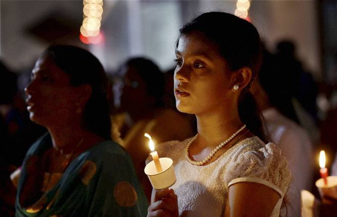 Christian devotees at midnight mass on Easter at Santhome church in Chennai