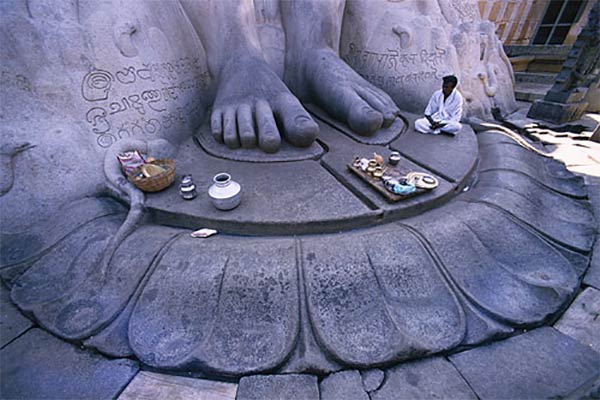 Jain followers pray at Gommateshvara Bahubali at Shravanabelagola