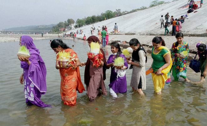 Hindu devotees carry Saakh depicting Goddess Durga for immersion in the River Tawi on the on the occasion of Ram Navami in Jammu