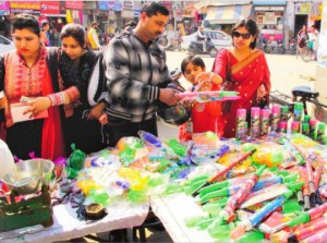 People buy sprinklers pichkaris and colours ahead of the Holi Festival in Bathinda