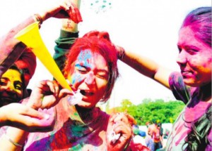 Students of Panjab University play with colours on the eve of Holi in Chandigarh