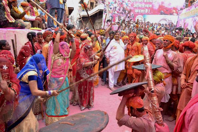 Women of Barsana beating men of Nandgaon with sticks during Lathmaar Holi celebration in Barsana, Mathura