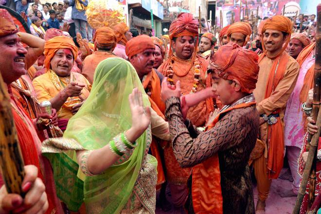 Women of Barsana beating men of Nandgaon with sticks during Lathmaar Holi celebration in Barsana, Mathura