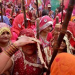 Women of Barsana beating men of Nandgaon with sticks during Lathmaar Holi celebration in Barsana, Mathura