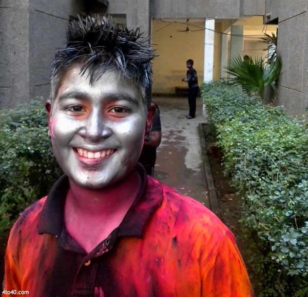 Children face with metallic colors of Holi