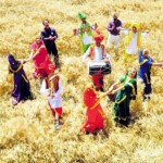 Teachers and students of a school perform bhangra and gidda on the eve of Baisakhi in a field at Reethkheri Village in Patiala