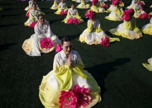 A Buddhist believer prays before a lotus lantern parade in celebration of the upcoming birthday of Buddha in Seoul, South Korea, on May 16, 2015.