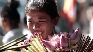 A Cambodian vendor holds flowers during the Buddhist Visak Bochea