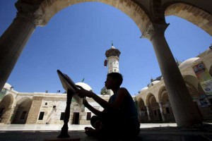 A Palestinian boy reads the Koran during the holy month of Ramadan at Sayed Hashim Mosque in Gaza City
