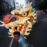 Buddhist believers march with a dragon-shaped lantern during a lotus lantern parade in celebration of the upcoming birthday of Buddha in Seoul, South Korea, on May 16, 2015.