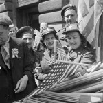 Canadian soldiers and members of the Canadian Women's Army Corps (CWAC) buy flags to wave in the VE-Day celebrations, in London May 8,1945