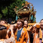Female local residents carry a portable shrine during the Kanda-Myojin shrine's summer festival, called the Kanda Matsuri on May 10, 2015.