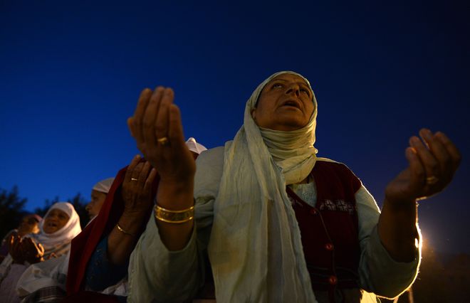 Kashmiri Muslims pray as an unseen custodian displays a holy relic, believed to be a hair from the Prophet Muhammad's beard, during the last Friday of celebrations for Miraj-Ul-Alam (Ascension to Heaven) at Kashmir's main Hazratbal Shrine in Srinagar on May 22, 2015.