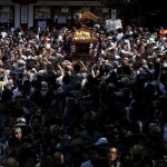 Local residents carry a portable shrine into the Kanda-Myojin shrine during the Kanda festival in Tokyo, Japan, on May 10, 2015.