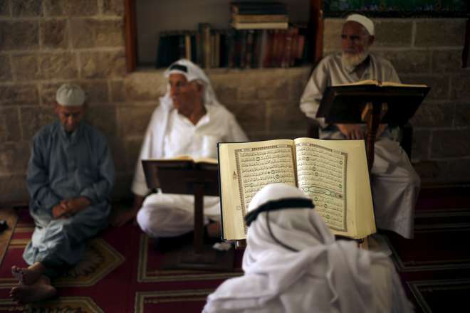 Palestinians read the Koran during the holy month of Ramadan at Sayed Hashim Mosque in Gaza City