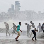 Mumbaikars enjoy high tide as monsoon hits Mumbai on June 14, 2015