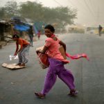 People are caught in a dust storm in New Delhi, India May 23, 2016