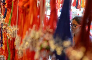A woman looks at 'rakhis' (sacred thread) at a roadside shop ahead of the Hindu festival Raksha Bandhan in Mumbai on August 27, 2015