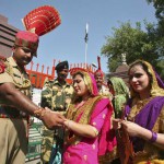 A woman ties a ‘rakhi’ onto the wrist of Border Security Force soldier during the Raksha Bandhan celebrations at the India-Pakistan joint check post at the Wagah border on the outskirts of Amritsar on August 29, 2015