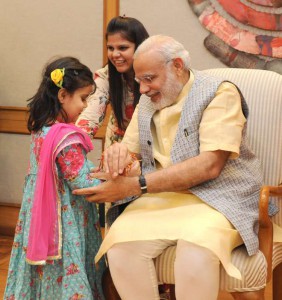 Children tying Rakhi to the Prime Minister Narendra Modi in New Delhi on August 29, 2015