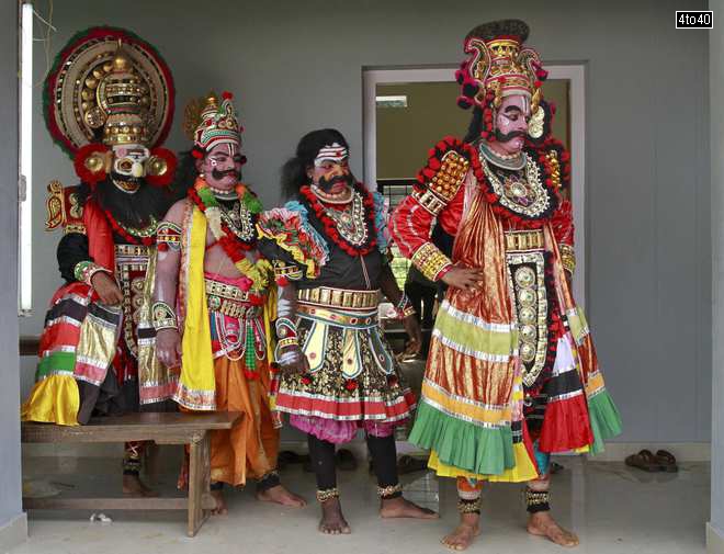 Dancers in traditional attires wait to take part in a performance during festivities marking the start of the annual harvest festival of ‘Onam’ in Kochi on August 19, 2015