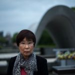 This picture taken on May 25, 2016 shows Keiko Ogura, 78, a survivor of the atomic bombing of Hiroshima in 1945, posing for a picture at the Hiroshima Peace Memorial Park in Hiroshima.