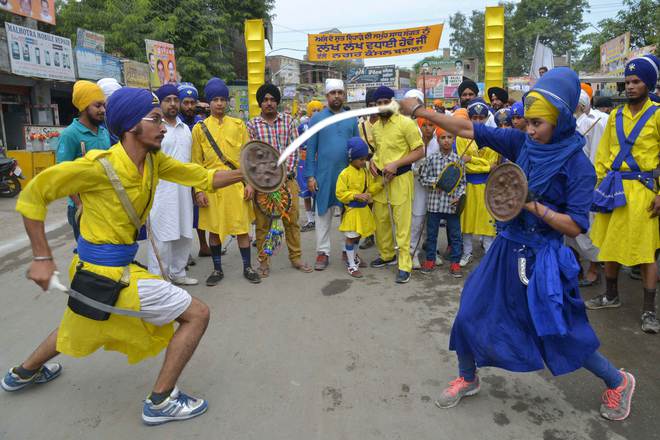 Nihang, religious Sikh warriors, show their skills in the Sikh martial art known as 'Gatka' during a procession for Guru Nanak Dev's marriage anniversary from the Gurdwara Sri Dehra Sahib temple to the Kandh Sahib temple in Batala, some 45 km (28 miles) northeast of Amritsar on September 20, 2015