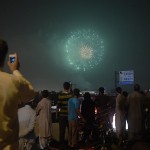 People watch a fireworks display marking Independence Day in Islamabad on August 13, 2015
