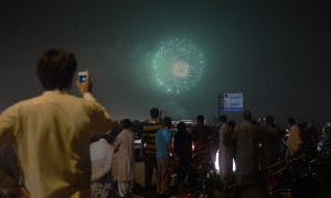People watch a fireworks display marking Independence Day in Islamabad on August 13, 2015