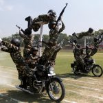 Policewomen perform a stunt on their motorbikes during the full-dress rehearsal ahead of India’s Independence Day celebrations in Srinagar on August 13, 2016