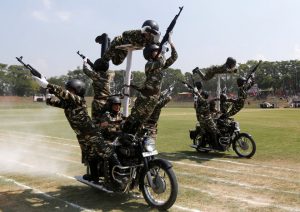 Policewomen perform a stunt on their motorbikes during the full-dress rehearsal ahead of India’s Independence Day celebrations in Srinagar on August 13, 2016