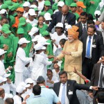 Schoolchildren and bystanders look on as Prime Minister Narendra Modi (C) walks among them after delivering his Independence Day speech from The Red Fort in New Delhi on August 15, 2015.