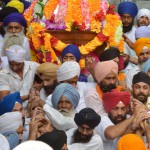 Sikh devotees carry the Palki Sahib with the Guru Granth Sahib as they take part in a procession for Guru Nanak Dev's marriage anniversary, from the Gurdwara Sri Dehra Sahib temple to the Kandh Sahib temple in Batala, some 45 kms (28 miles) northeast of Amritsar on September 20, 2015