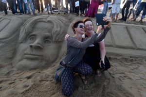 Some foreigners click a selfie with a sand sculpture of former president APJ Abdul Kalam on his 85th birth anniversary at Marina beach in Chennai on October 15, 2016. Kalam, India’s 11th President, died on July 27, 2015.
