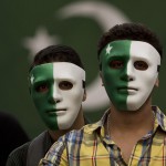 Youngsters wear masks painted in the design of the national flag